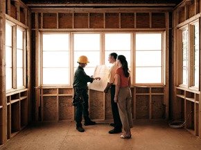 contractor showing floorplan to a couple: Real Estate Due Diligence in NYC