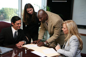 4 people negotiating a real estate deal: brokers, attorneys and clients in New York
