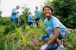 woman planting some fruits - gardening and smiling