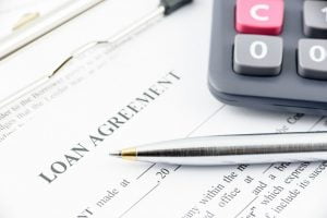 calculator and loan agreement for a mortgage - signature