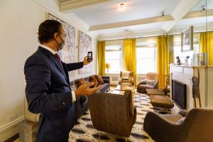 broker taking pictures of a new york city apartment - virtual showing