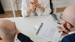Attorney and clients reviewing a residential contract