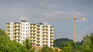 Apartment building under construction beside a tower crane