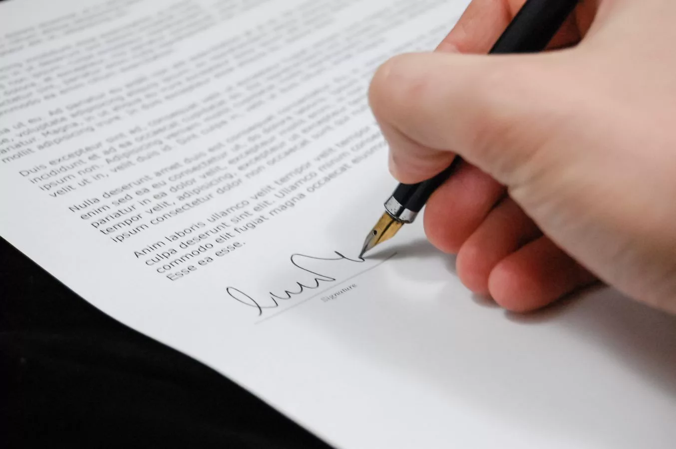 Signing real property transfer documents including the RP-5217 report at an NYC closing