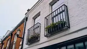 A Juliet balcony with a railing outside a door and no floor to stand on