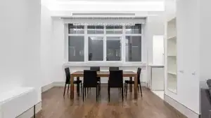 A dining alcove set back from the living room, the fourth room a junior 4 is named for