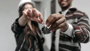 A couple holding the keys to their first New York City apartment