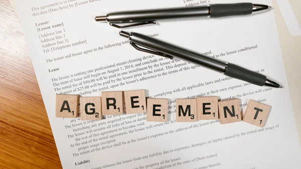 Proprietary lease and agreement documents on a desk