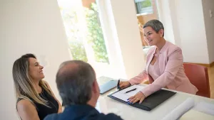 A buyer meeting their agent to go over a written buyer agreement