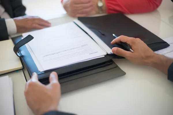 A NYC buyer and attorney reviewing CEMA paperwork with a lender