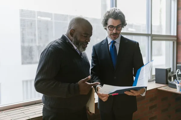 A NYC buyer and a family guarantor going over a co-op board package