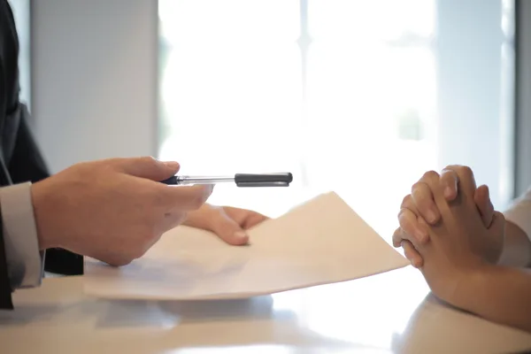 A NYC buyer reviewing conventional loan terms and a down payment schedule with a lender