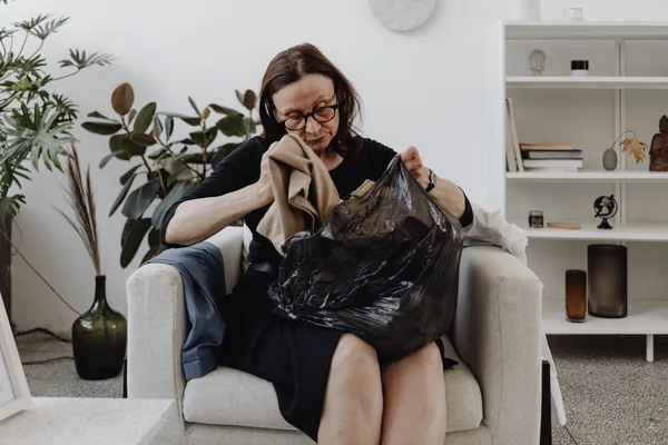 An older NYC homeowner sorting belongings while planning a move to a smaller apartment - downsizing to a smaller home