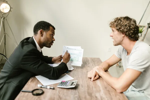 A buyer and their agent reviewing an escalation clause before submitting an offer