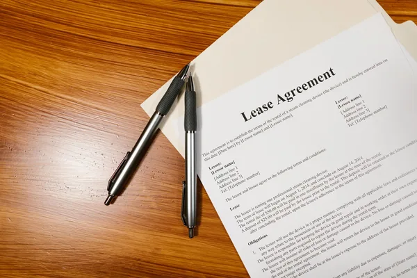 A renter and a family guarantor reviewing a NYC apartment application