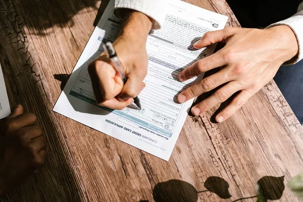 A homeowner reviewing a mortgage recast request with a lender