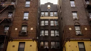 The brick facade and windows of a New York City apartment building