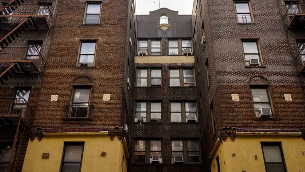 The brick facade and windows of a New York City apartment building