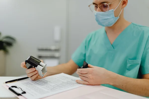 A physician reviewing mortgage paperwork with a lender before a NYC purchase