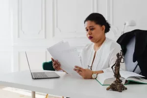 NYC Offering Plans: What the AG Actually Checks (Not Much) - A real estate attorney reviewing a NYC contract of sale and a co-op offering plan