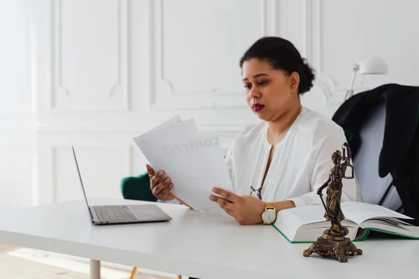 A real estate attorney reviewing a NYC contract of sale and a co-op offering plan