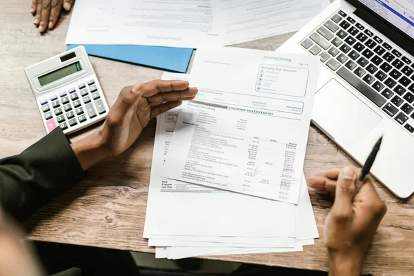 A homeowner reviewing refinance closing costs and a break-even calculation