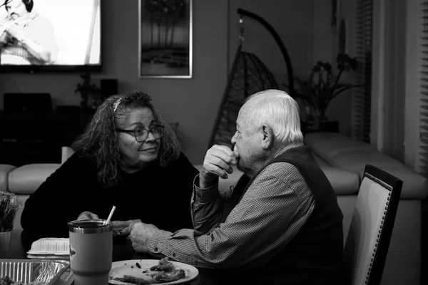 An older homeowner reviewing reverse mortgage paperwork with a counselor