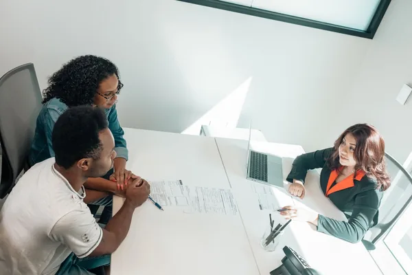 A buyer and a loan officer reviewing low-down-payment loan options at a desk